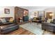 Comfortable living room with hardwood floors, brick fireplace, and plush leather sofas for relaxing and entertaining at 701 5Th Ne Ave, Conover, NC 28613