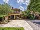 Expansive backyard features a tiled patio, covered porch and sports court, perfect for outdoor entertaining at 7011 Conservatory Ln, Charlotte, NC 28210