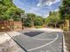 Enjoy a private basketball court perfect for recreation, complete with a brick surround and lush landscaping at 7011 Conservatory Ln, Charlotte, NC 28210