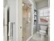 Modern bathroom featuring a glass enclosed shower with a window, and floating shelves at 7011 Conservatory Ln, Charlotte, NC 28270