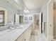 Bright bathroom featuring double vanity with marble countertop, large mirror, and an open layout at 7011 Conservatory Ln, Charlotte, NC 28210