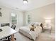 Cozy bedroom with two windows, a bed with white comforter, and an adjacent desk area at 7011 Conservatory Ln, Charlotte, NC 28270