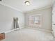 Empty bedroom with neutral carpet, white walls, a window with blinds, and a full length mirror at 7011 Conservatory Ln, Charlotte, NC 28210