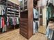 Walk-in closet with custom shelving, wooden floors, and ample storage space for clothes and accessories at 7011 Conservatory Ln, Charlotte, NC 28210