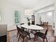 Dining room with a long oval table and hardwood floors with a rug at 7011 Conservatory Ln, Charlotte, NC 28210