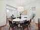 Dining area adjacent to office and living spaces with hardwood floors and white trim at 7011 Conservatory Ln, Charlotte, NC 28210