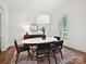 Bright dining room with a modern light fixture, neutral decor, and hardwood floors at 7011 Conservatory Ln, Charlotte, NC 28210