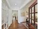 Inviting foyer showcasing hardwood floors, natural light, and entry to living spaces at 7011 Conservatory Ln, Charlotte, NC 28210