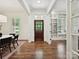 Spacious foyer with hardwood floors, a dark door, and view to the interior at 7011 Conservatory Ln, Charlotte, NC 28210