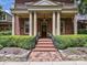 Stately brick home featuring a grand front entrance with brick steps, and large support columns at 7011 Conservatory Ln, Charlotte, NC 28210