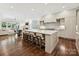 Open concept kitchen with a large island, seating, and view into the living room at 7011 Conservatory Ln, Charlotte, NC 28210