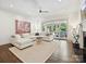 Spacious living room with hardwood floors, fireplace, and large sectional couch at 7011 Conservatory Ln, Charlotte, NC 28210
