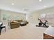 Living room features large windows, neutral carpeting, a large sectional sofa, and ample space at 7011 Conservatory Ln, Charlotte, NC 28210