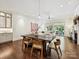 Well-lit living room with a wooden dining table and hardwood floors at 7011 Conservatory Ln, Charlotte, NC 28210
