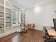 Bright and airy office space featuring hardwood floors and built-in bookshelves at 7011 Conservatory Ln, Charlotte, NC 28210