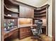 Well-appointed home office with custom built-ins, wood floors, and a comfortable ergonomic chair at 7011 Conservatory Ln, Charlotte, NC 28210