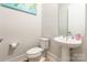 This half-bathroom features a sink with pedestal and modern fixtures at 8008 Brookbank Dr, Charlotte, NC 28269