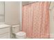 This half-bathroom includes stylish shower curtain with modern fixtures at 8008 Brookbank Dr, Charlotte, NC 28269