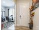 Inviting entryway leads to a home office space with a glass desk, patterned rug, and stylish decor at 8008 Brookbank Dr, Charlotte, NC 28269