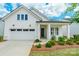 Charming white exterior of a single-story home, with a manicured front lawn and attached two-car garage at 8008 Brookbank Dr, Charlotte, NC 28269