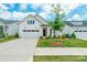 Charming single-story home featuring a white exterior, well-manicured lawn, and attached two car garage at 8008 Brookbank Dr, Charlotte, NC 28269