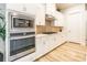 The kitchen boasts stainless steel appliances, white cabinets, and a stylish backsplash at 8008 Brookbank Dr, Charlotte, NC 28269