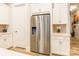 Stainless steel refrigerator surrounded by white cabinets and countertops at 8008 Brookbank Dr, Charlotte, NC 28269