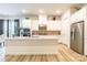 Bright kitchen boasts white cabinetry, stainless steel appliances, and a large island, perfect for entertaining at 8008 Brookbank Dr, Charlotte, NC 28269