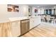 Kitchen island with stainless steel dishwasher, sink, and white cabinets at 8008 Brookbank Dr, Charlotte, NC 28269