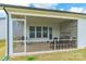 This screened patio features a stone fireplace and outdoor seating at 8008 Brookbank Dr, Charlotte, NC 28269