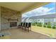 Relax on this covered patio with stone fireplace and backyard views at 8008 Brookbank Dr, Charlotte, NC 28269