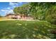 Expansive backyard featuring lush green grass, mature trees, and charming exterior home at 908 Taylor St, Kannapolis, NC 28083