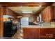 Open kitchen view featuring vintage appliances, custom wood cabinets, and a retro design at 908 Taylor St, Kannapolis, NC 28083