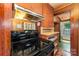 View of a vintage kitchen with black range oven and hood at 908 Taylor St, Kannapolis, NC 28083