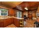 Well-lit vintage kitchen with wood cabinets, unique flooring, and ample counter space at 908 Taylor St, Kannapolis, NC 28083