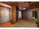 Inviting living room showcasing wood paneling, carpeted floors, and a classic design at 908 Taylor St, Kannapolis, NC 28083