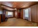 Comfortable living room with wood paneling, carpeted floors, and natural light from large windows at 908 Taylor St, Kannapolis, NC 28083
