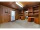 Private office featuring built-in shelving, wood-paneled walls, and door access at 908 Taylor St, Kannapolis, NC 28083