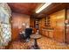 Cozy wood-paneled office space with built-in cabinets, desk area, and unique flooring at 908 Taylor St, Kannapolis, NC 28083