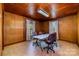 Spacious office with wood-paneled walls, neutral flooring, and abundant natural light from the two large windows at 908 Taylor St, Kannapolis, NC 28083