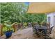 Inviting wooden back deck with a dining table, multiple chairs, and a shade sail for outdoor relaxation at 9513 Tresanton Dr, Charlotte, NC 28210