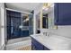 Stylish bathroom with dark blue subway tile, glass shower, vanity with sink, and modern fixtures at 9513 Tresanton Dr, Charlotte, NC 28210