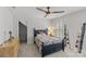 Comfortable bedroom with a full-sized bed, wooden ceiling fan, and natural light from shuttered windows at 9513 Tresanton Dr, Charlotte, NC 28210