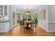 Sunlit dining room featuring a round table, hardwood floors, and walls of windows offering backyard views at 9513 Tresanton Dr, Charlotte, NC 28210