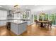 Stunning, bright kitchen with white cabinets, granite countertops, stainless steel appliances, and a large island at 9513 Tresanton Dr, Charlotte, NC 28210