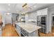 Spacious kitchen features a large center island with stone countertop, stainless steel appliances and bright lighting at 9513 Tresanton Dr, Charlotte, NC 28210