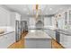 Open-concept kitchen showcasing stainless steel appliances, white cabinets, granite countertops, and a bright eat-in area at 9513 Tresanton Dr, Charlotte, NC 28210