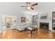 Elegant living room showcasing hardwood floors, a fireplace with built-in shelving, and comfortable seating at 9513 Tresanton Dr, Charlotte, NC 28210