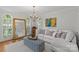 Bright living room featuring a sectional sofa, statement mirror, and large windows providing ample natural light at 9513 Tresanton Dr, Charlotte, NC 28210