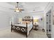 Relaxing main bedroom with a large bed, ceiling fan and natural light at 9513 Tresanton Dr, Charlotte, NC 28210